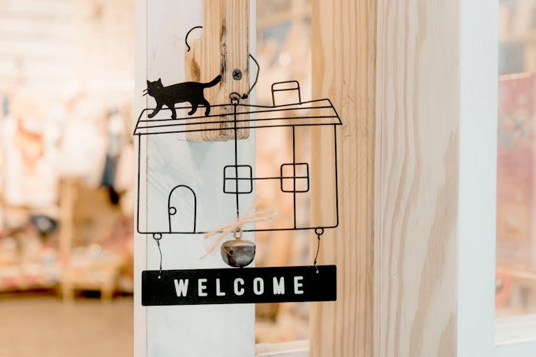 Interior design wooden door decoration featuring a welcome sign with cat silhouette.